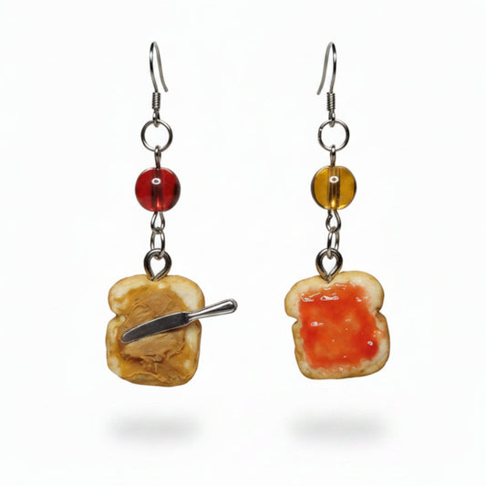 Earrings with toast and jelly design on a pink background