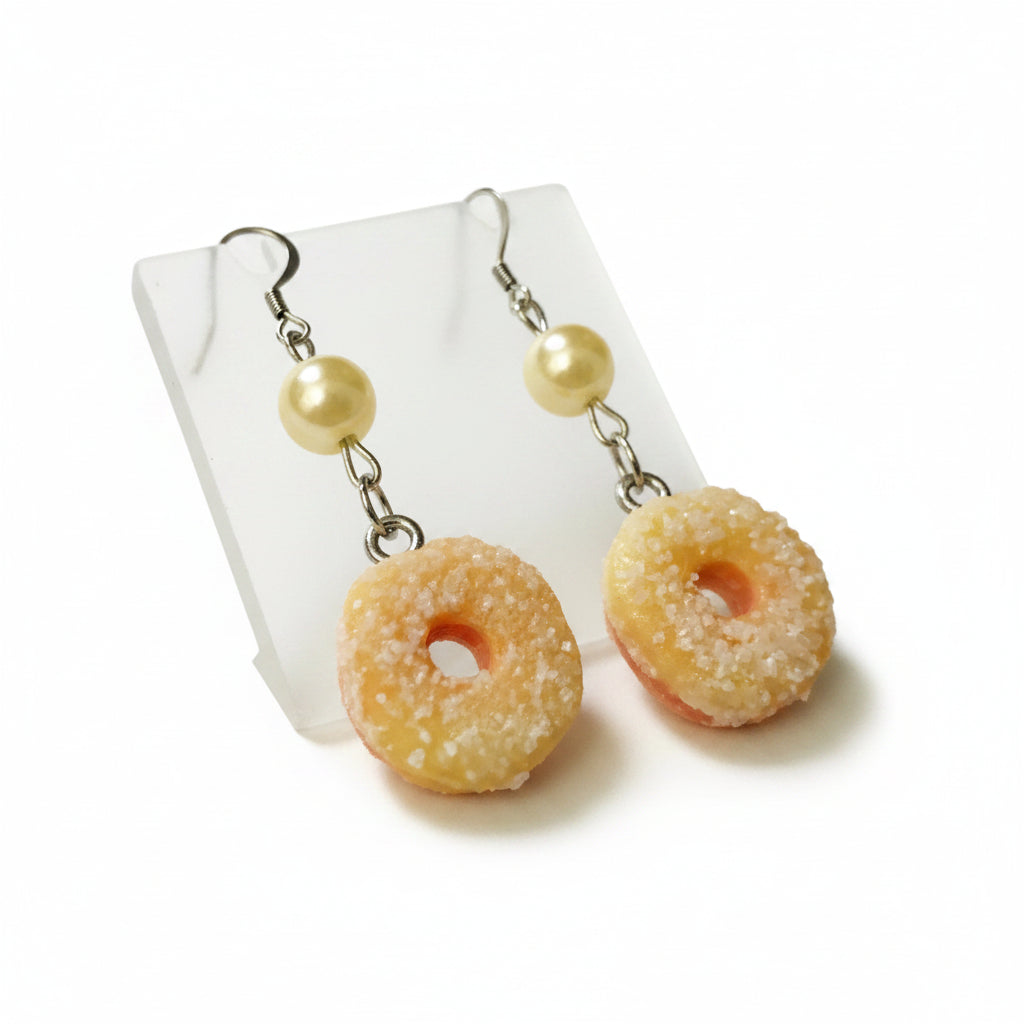 peach ring earrings with yellow beads on a light  background
