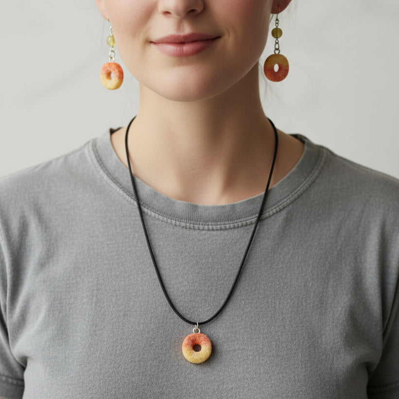 Woman wearing a necklace and earrings with a plain background