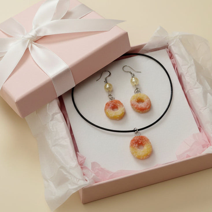 ring shaped jewelry set with necklace and earrings on a beige background