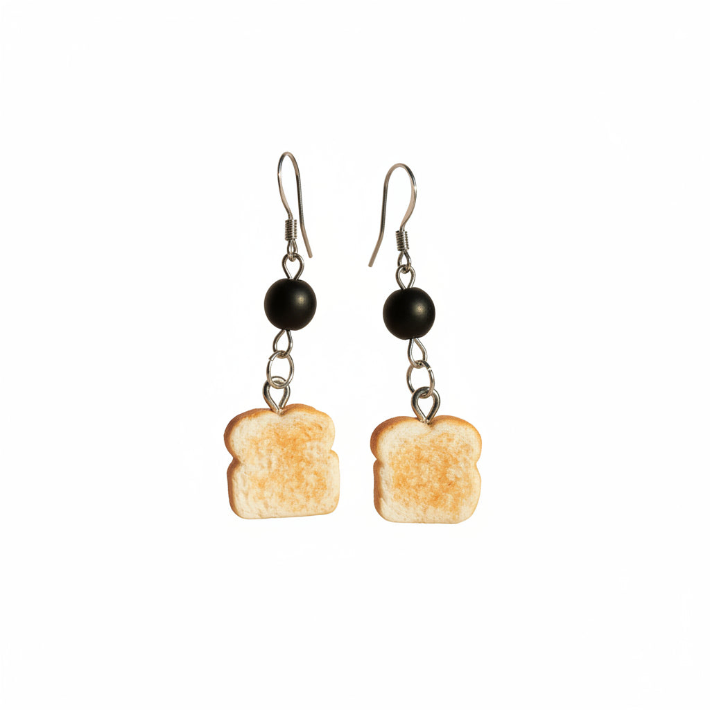 Toast-shaped earrings with black beads on a gray background