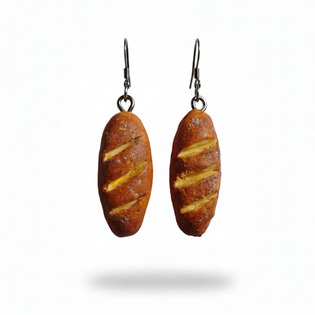 Loaf of bread-shaped earrings on a plain background
