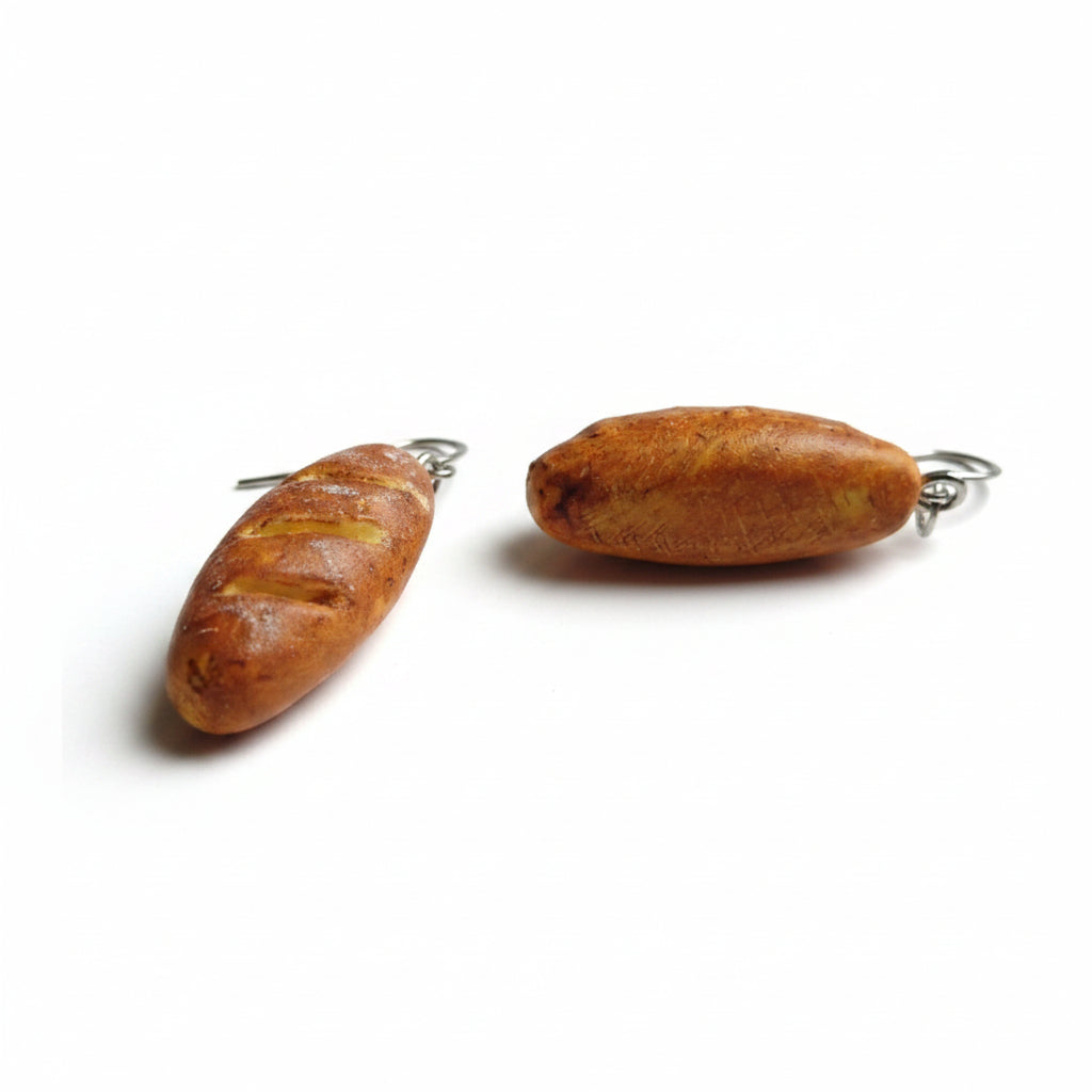 baguette shaped earrings on a plain background
