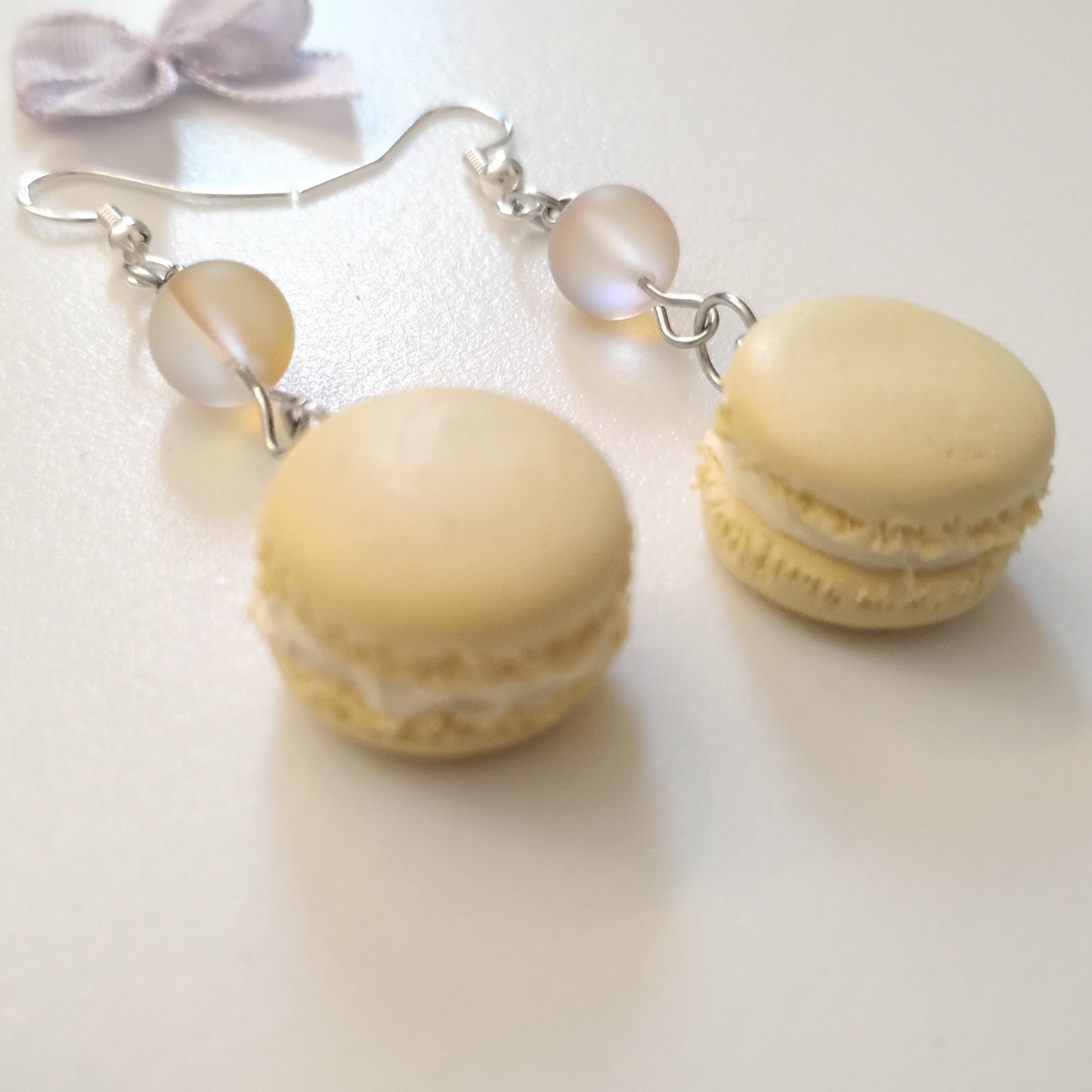 Macaron-shaped earrings on a white background