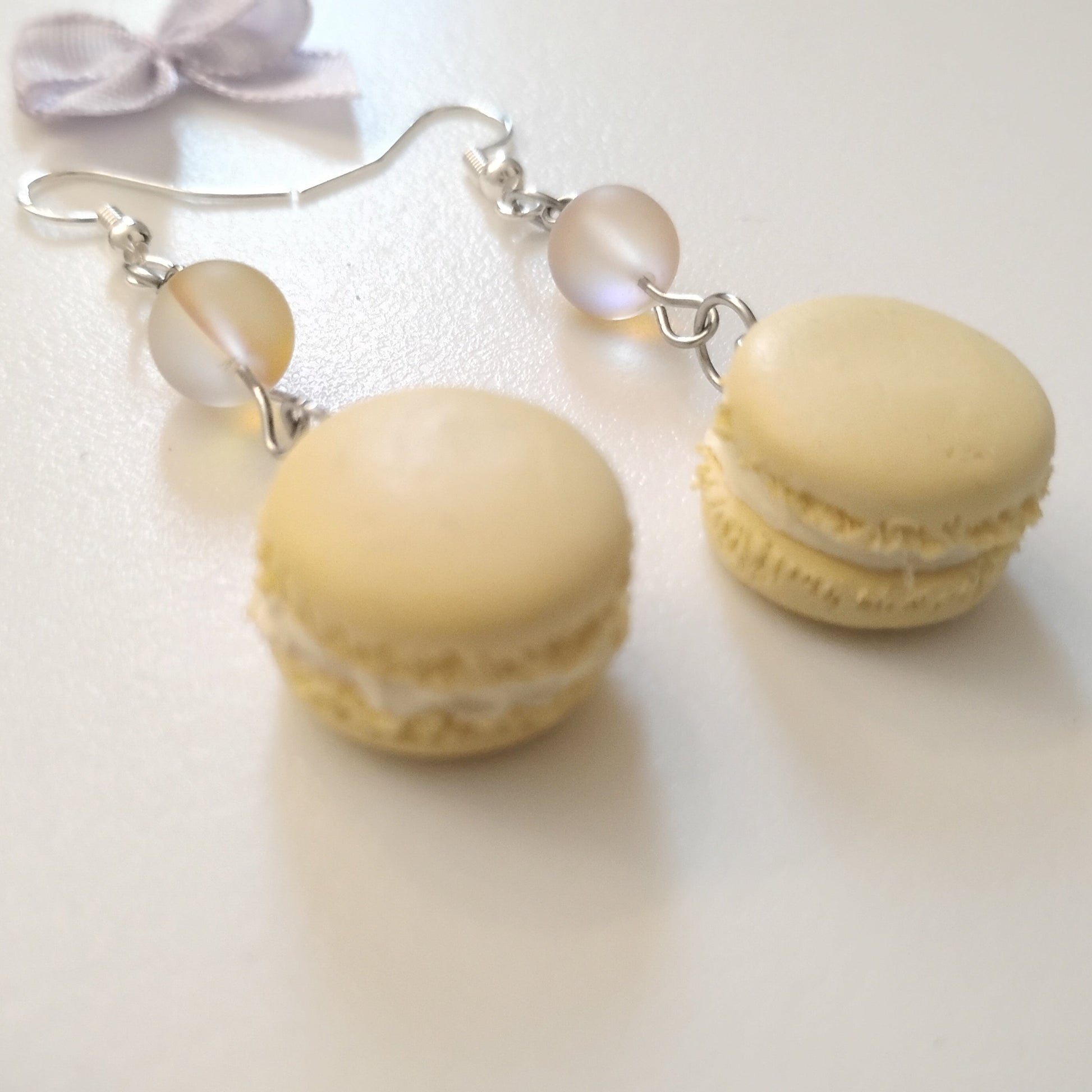 Macaron-shaped earrings on a white background