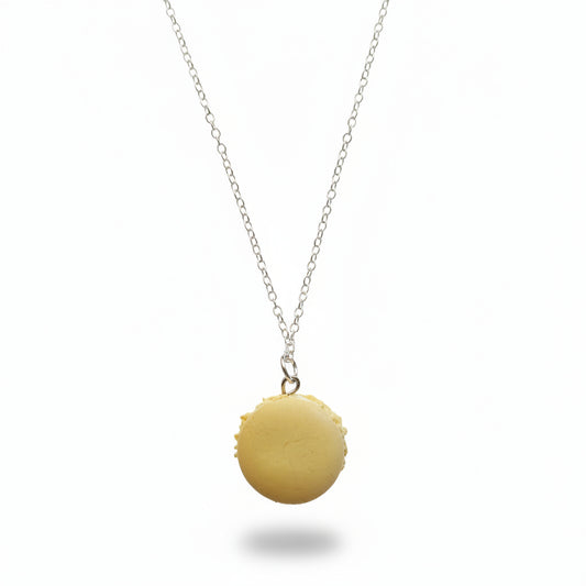 Yellow macaron-shaped pendant on a silver chain against a plain background