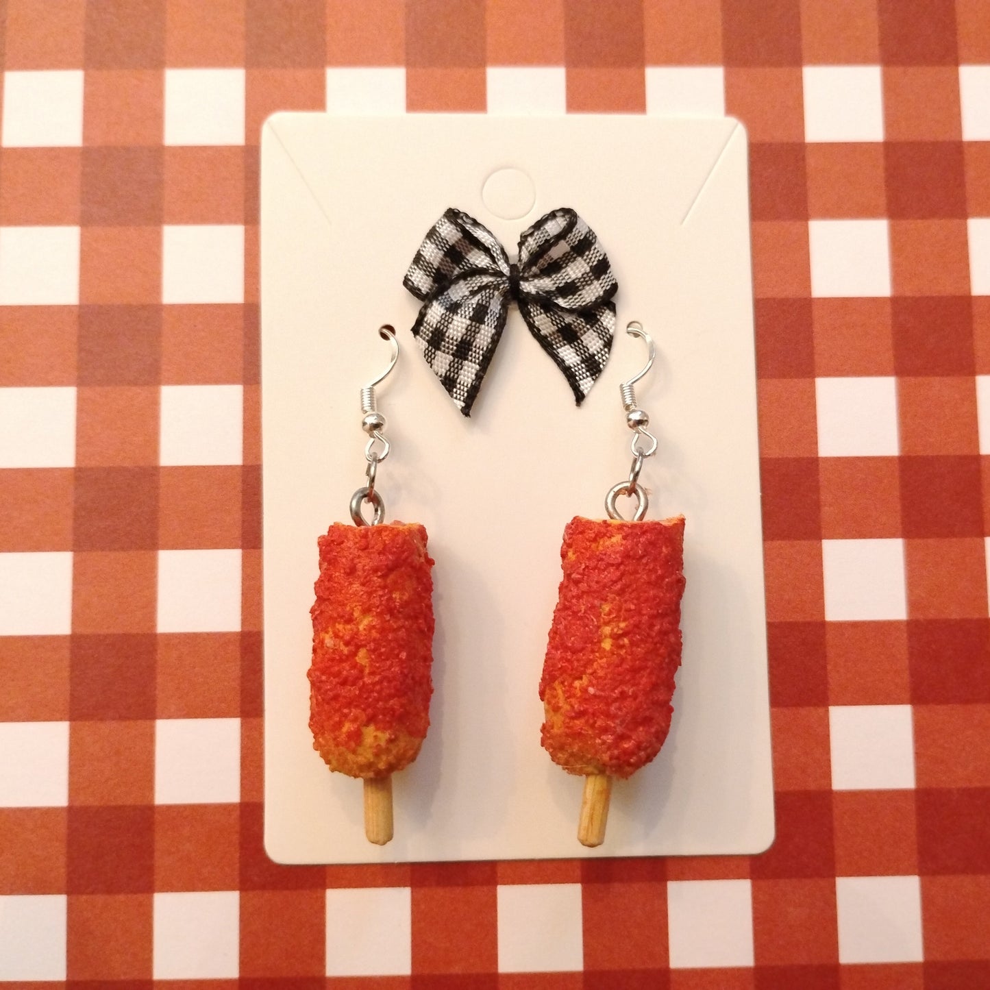 Korean corn dogs earrings on red plain table