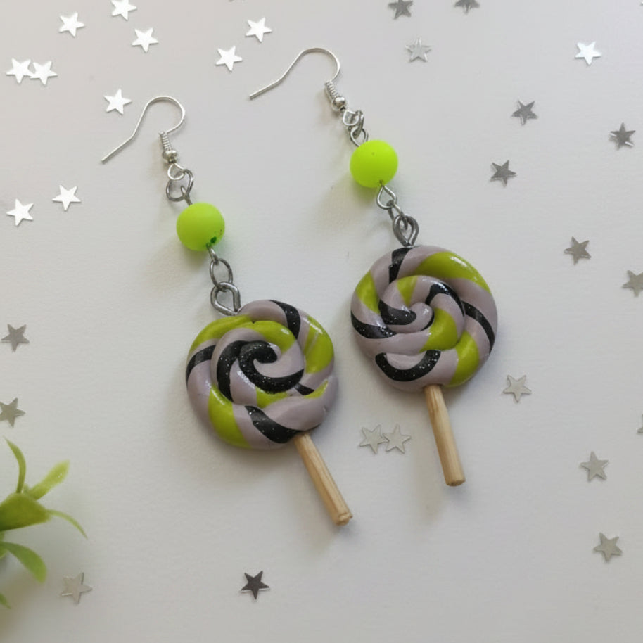 Lollipop-shaped earrings with green, black, and gray design on a white background