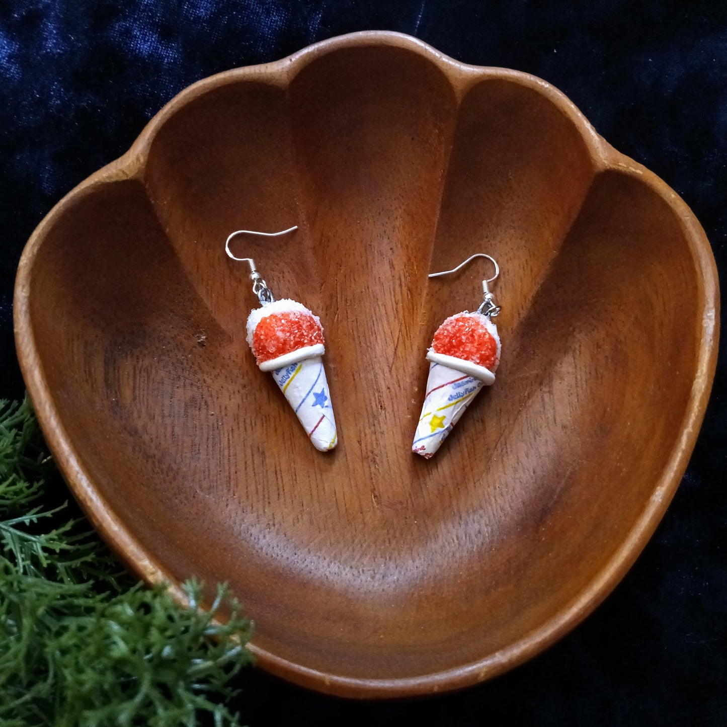 patriotic snow cone earrings on a wooden dish with a dark background