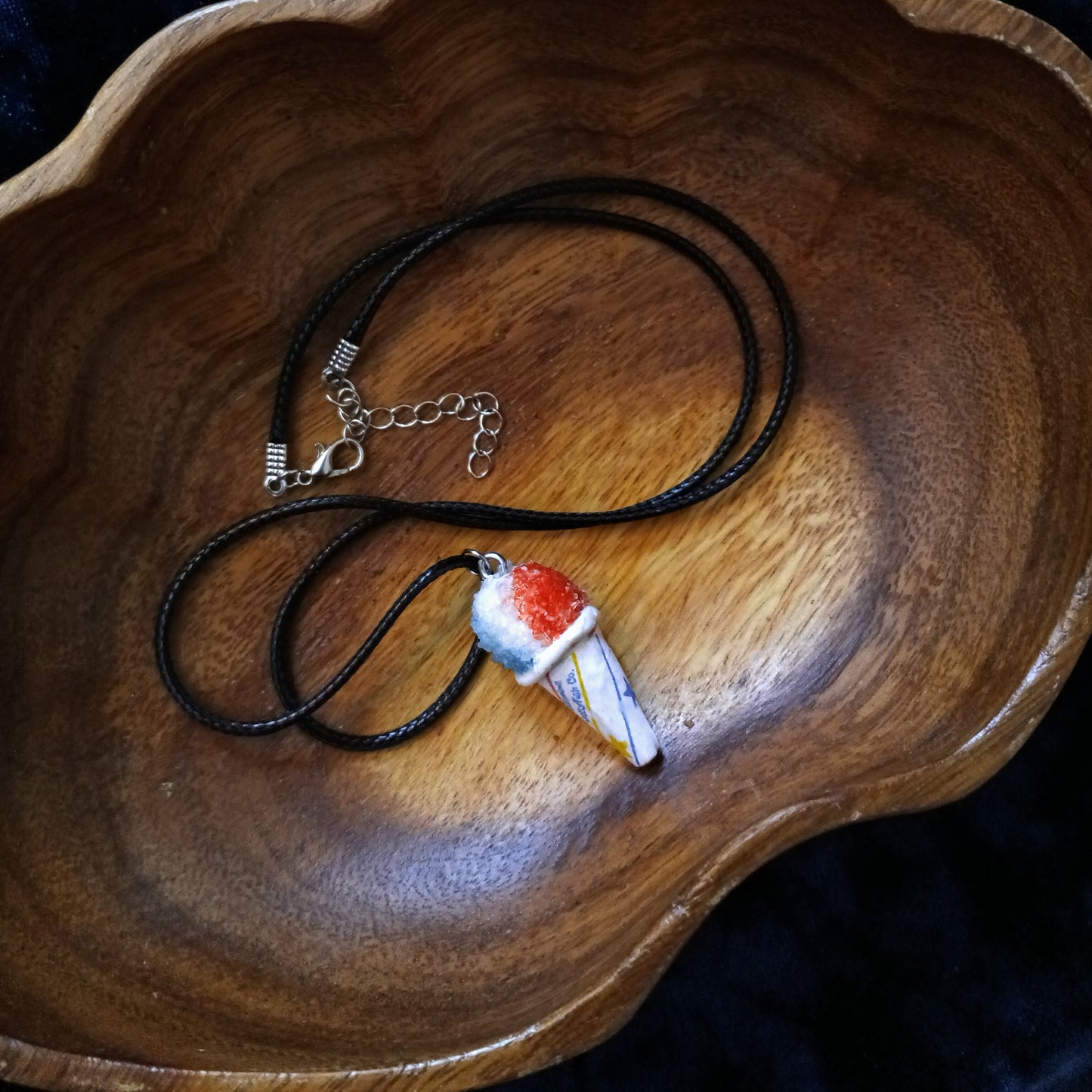 Necklace with a unique pendant on a wooden surface