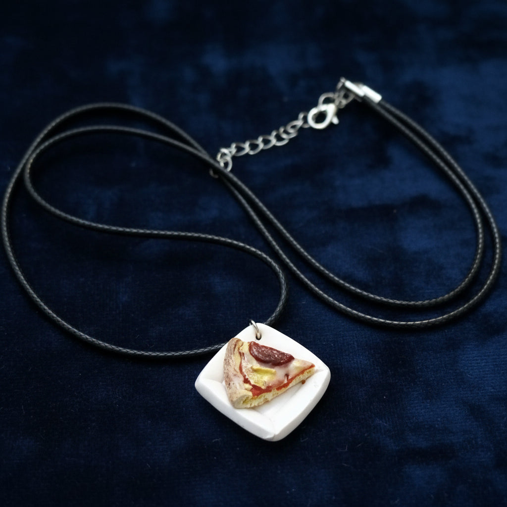 Necklace with a pendant shaped like a slice of pizza on a blue background