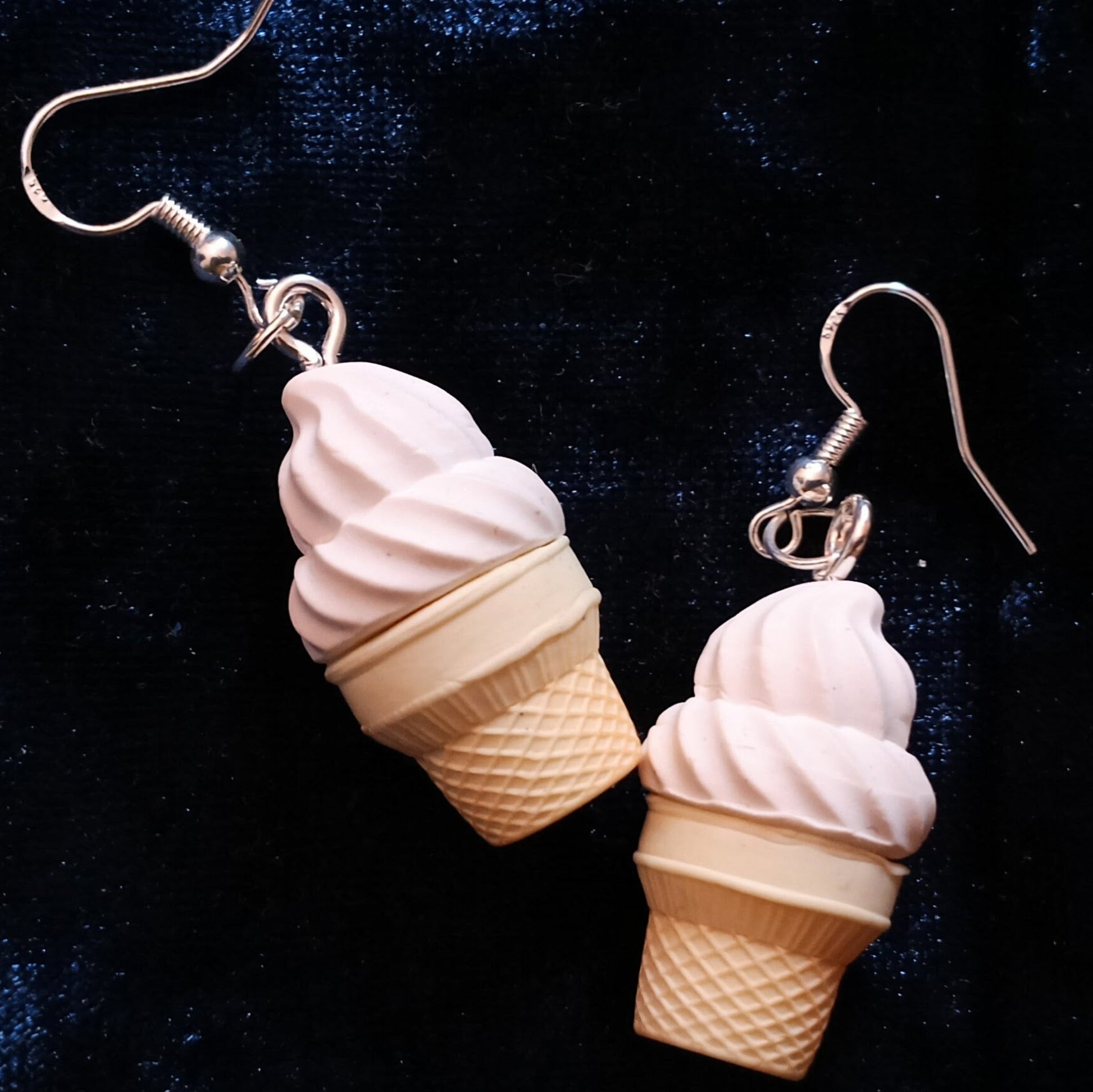 Ice cream cone earrings on a dark background