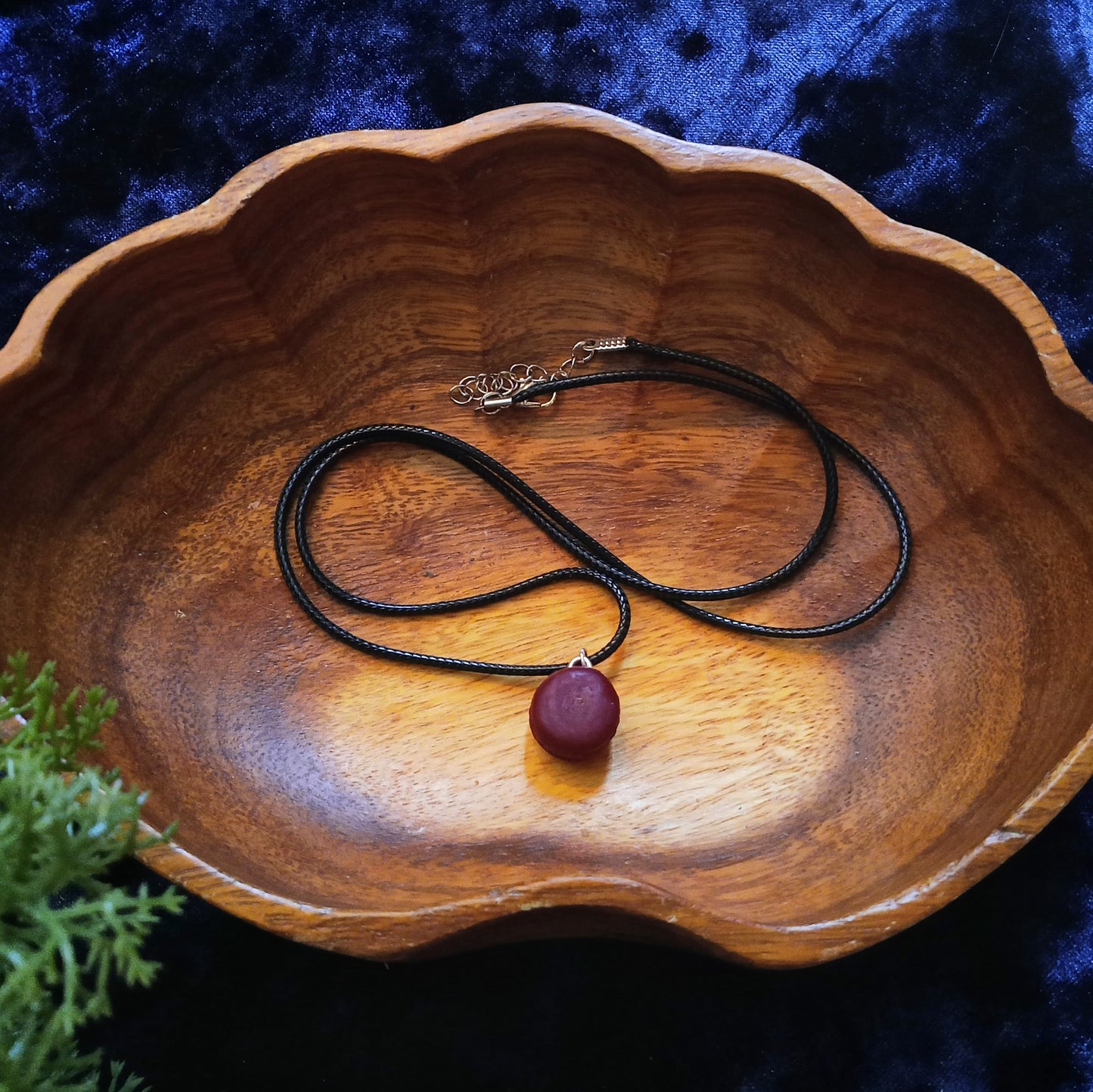 macaron necklace in wooden bowl
