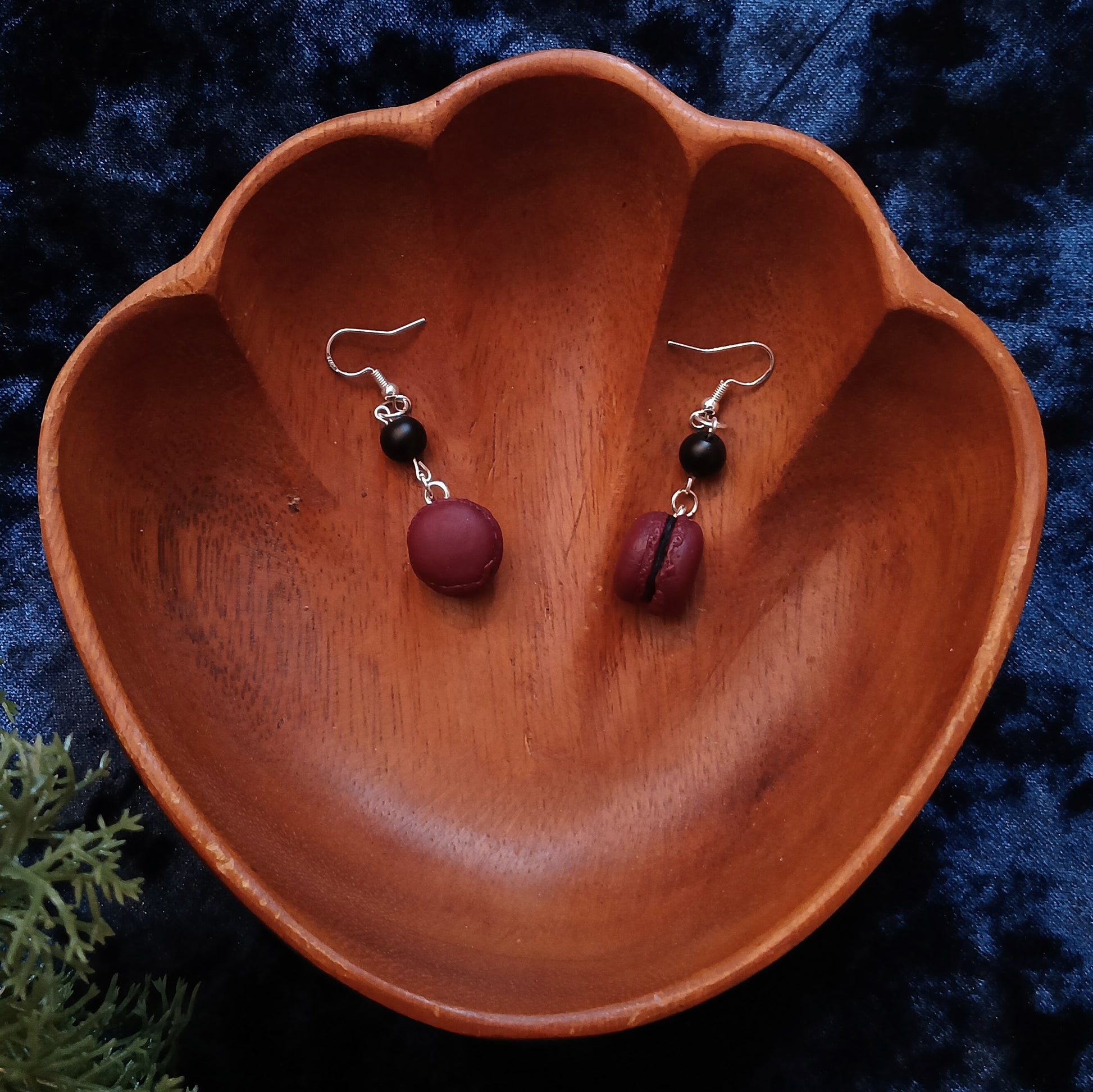 macaron earrings with bead on wooden bowl