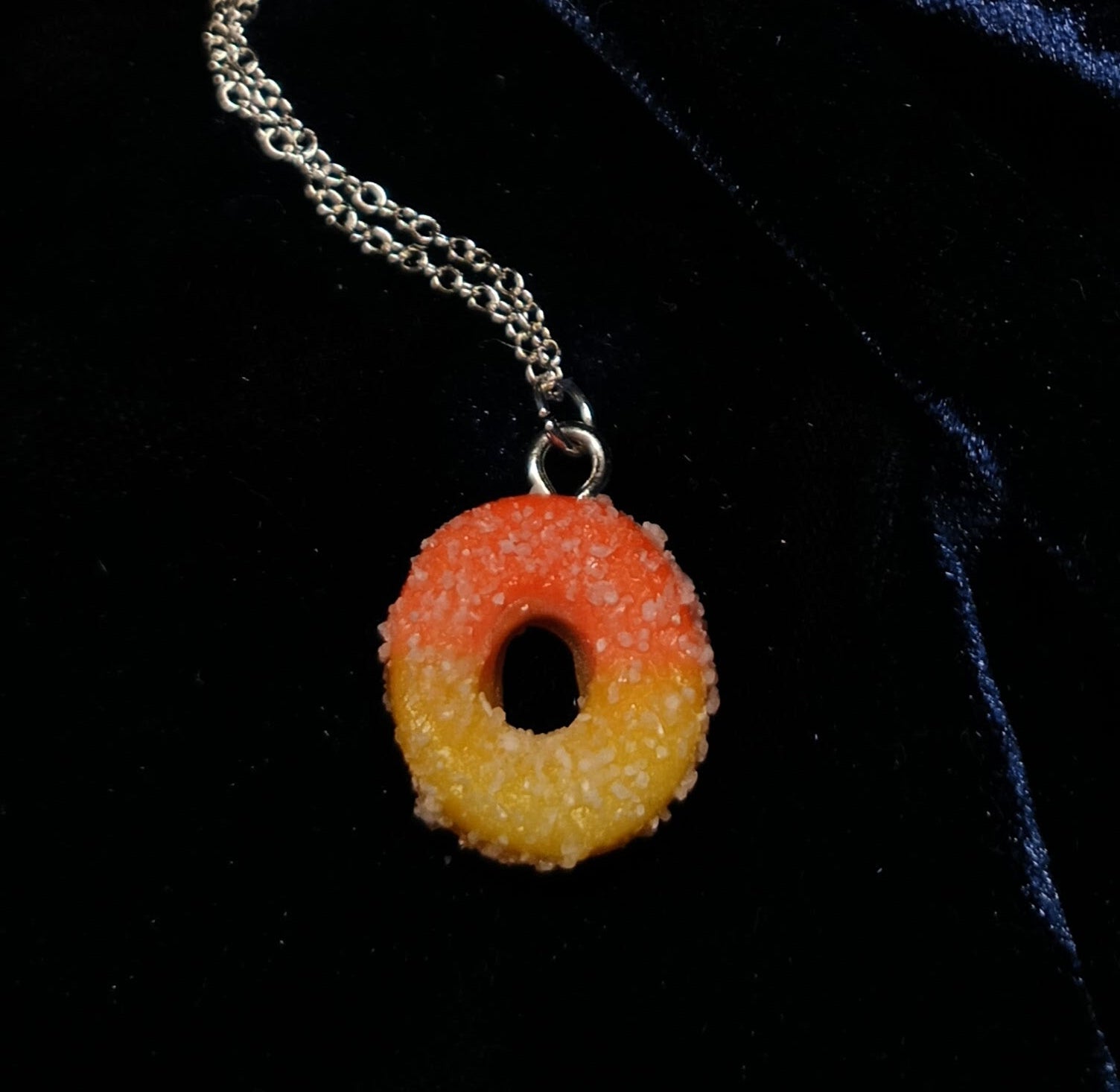 peach ring pendant necklace on dark background