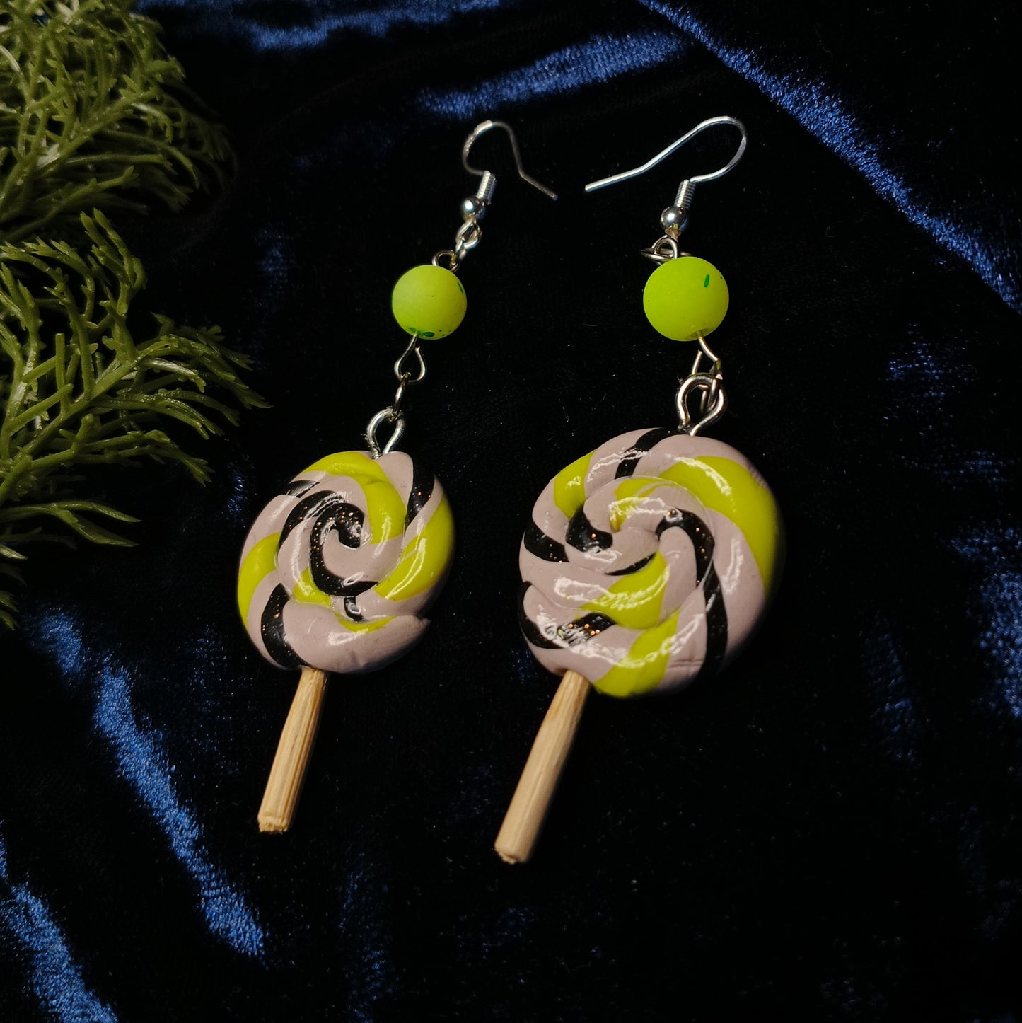 lollipop swirl earrings on dark background