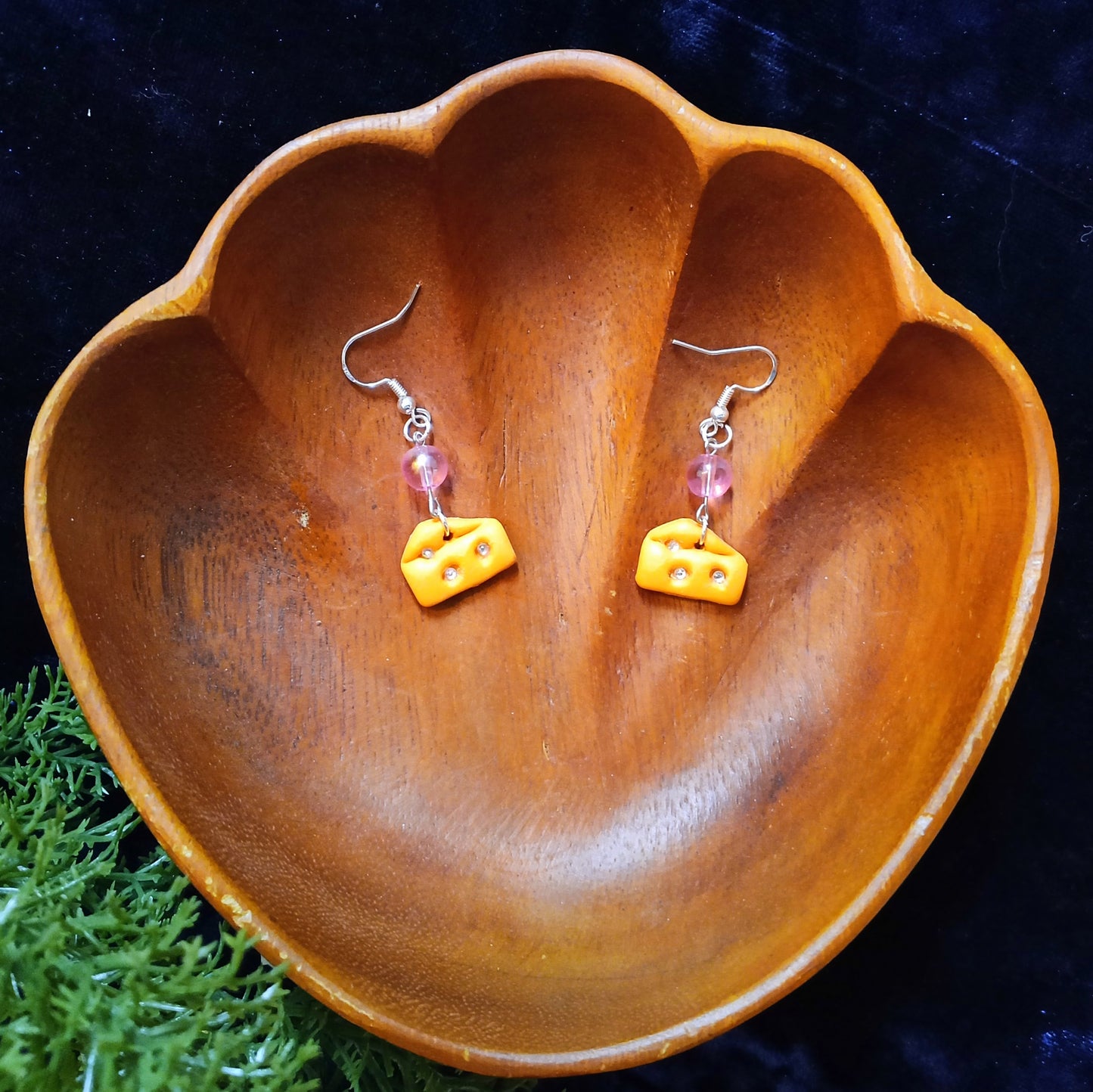 cheese wedge earrings in wooden bowl
