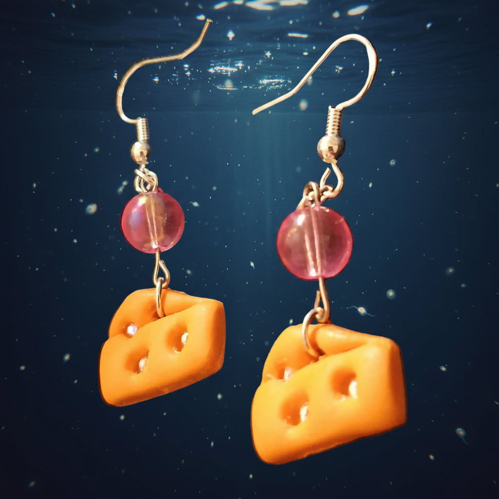 Cheese wedge and pink bead earrings on a aquatic background