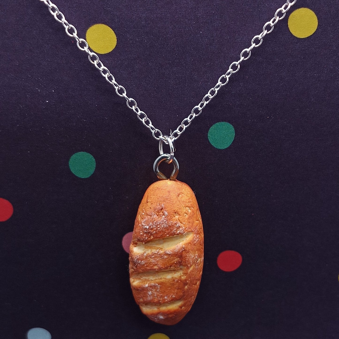 Baguette pendant on silver chain necklace with polka dot background 