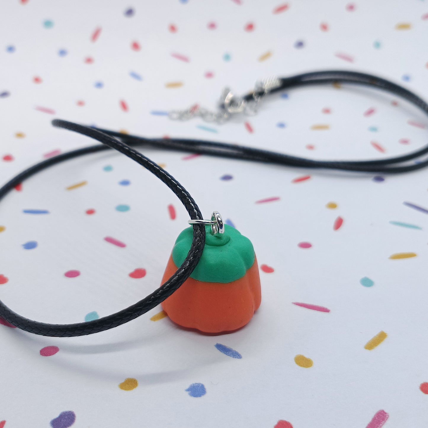 pumpkin candy corn necklace on confetti background