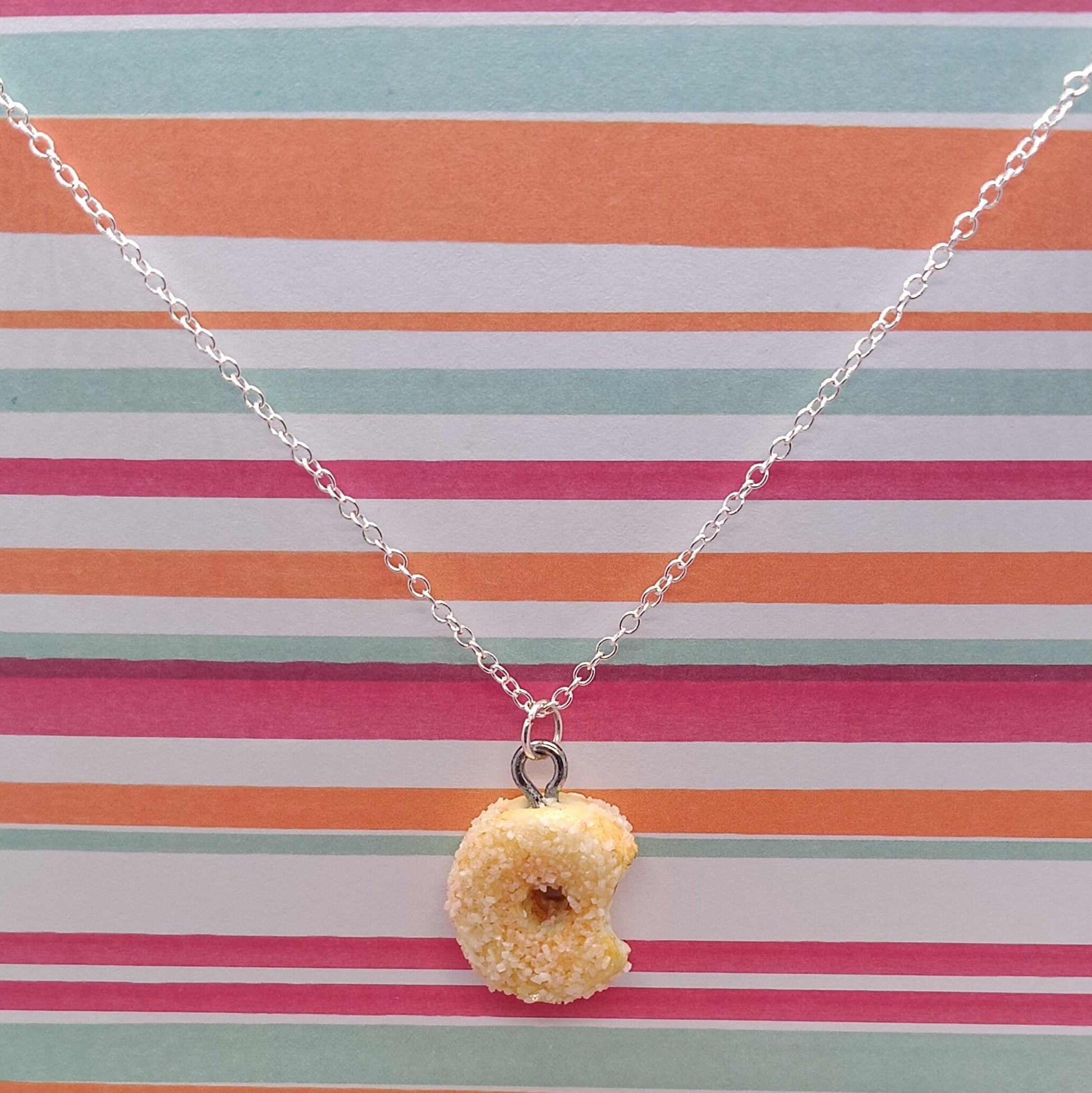 Sugar Donut Pendant on silver chain and striped background