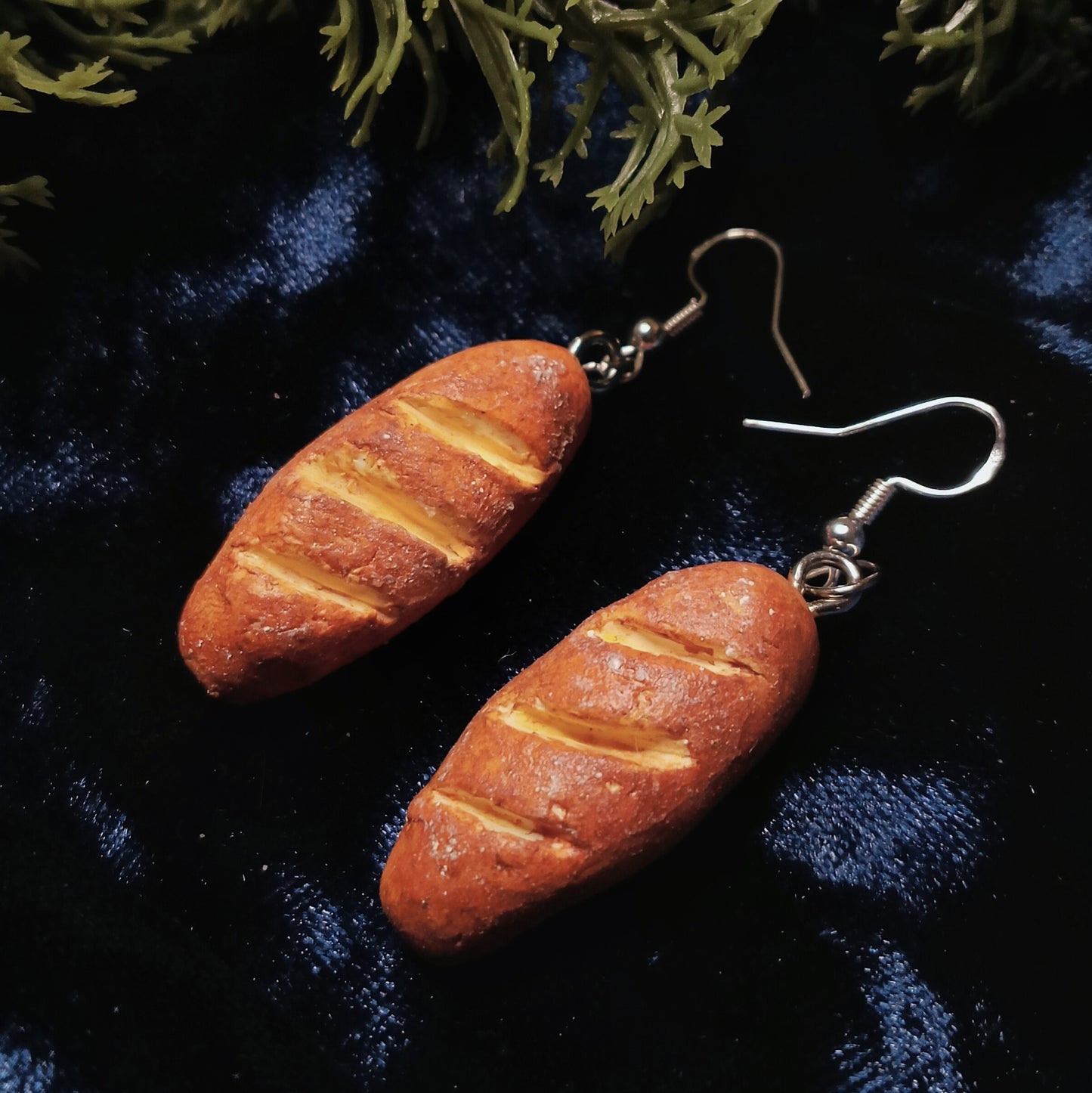 baguette earrings on dark background
