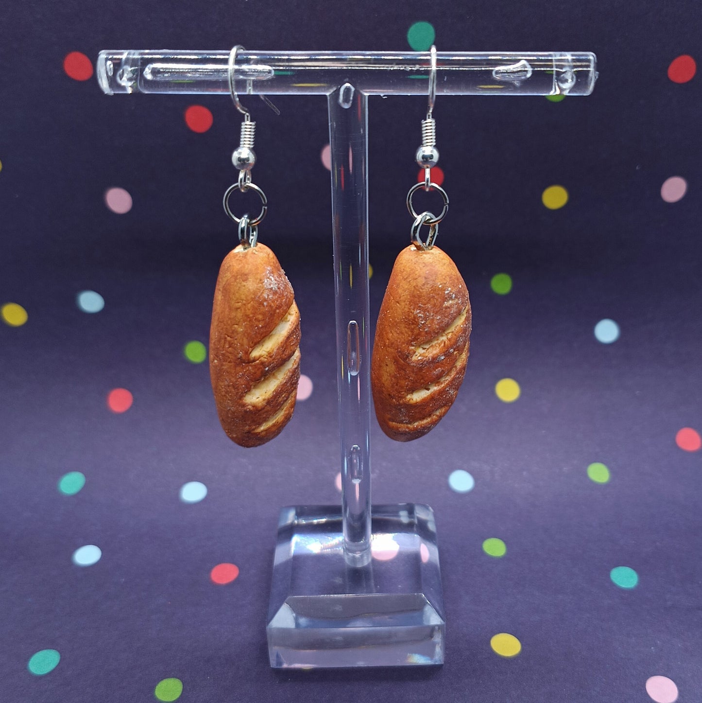 Baguette dangle earrings on polka dot background 